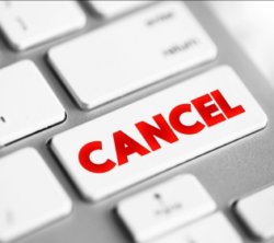 A close-up of a computer keyboard with a highlighted key that says “Cancel” in red.