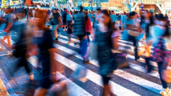Many people crossing a busy intersection in the city; Copyright: Adobe Express