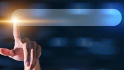 A finger touches a modern, glowing search bar as a symbol of AI-powered search.